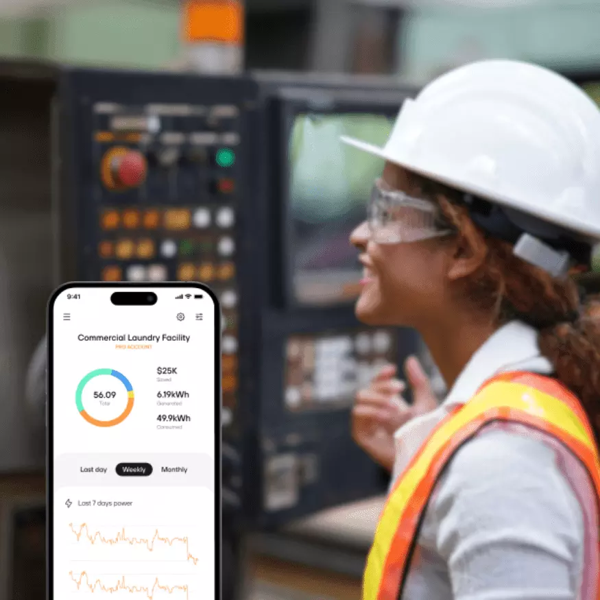 facility operations expert in facility with mobile energy dashboard in the foreground